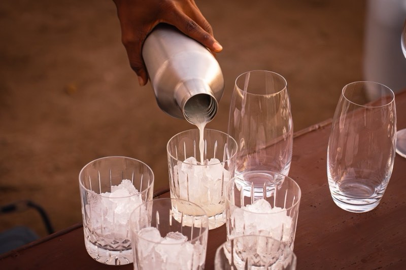 Pouring cocktails into crystal glasses